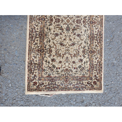 765 - A Beige bordered Runner with floral and leafage design 7ft 7