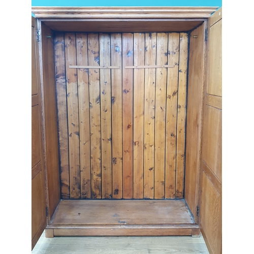 9 - A Heals oak Double Wardrobe with moulded cornice and pair of octagonal panelled doors, with inset iv... 