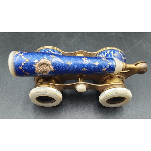 98 - A pair of blue enamel and gilt metal Opera Glasses decorated gilt floral swags A/F