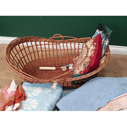 229 - A wicker Baby Basket and a quantity of Blankets and Textiles (R8)