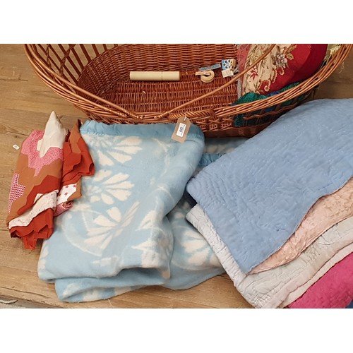 229 - A wicker Baby Basket and a quantity of Blankets and Textiles (R8)