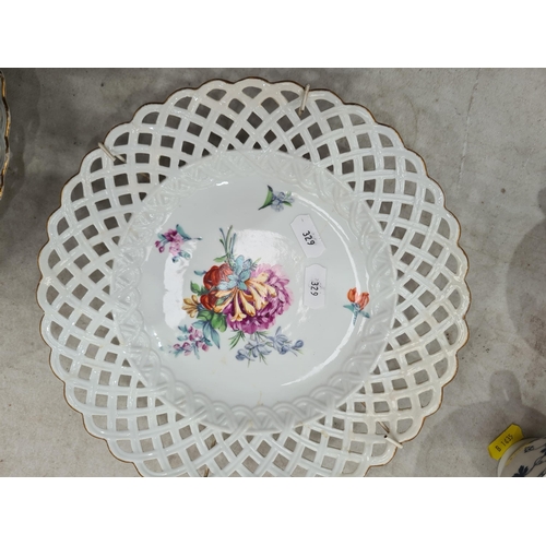 329 - Six hand painted Dresden Plates with pierced rims, with central floral decorations, 9