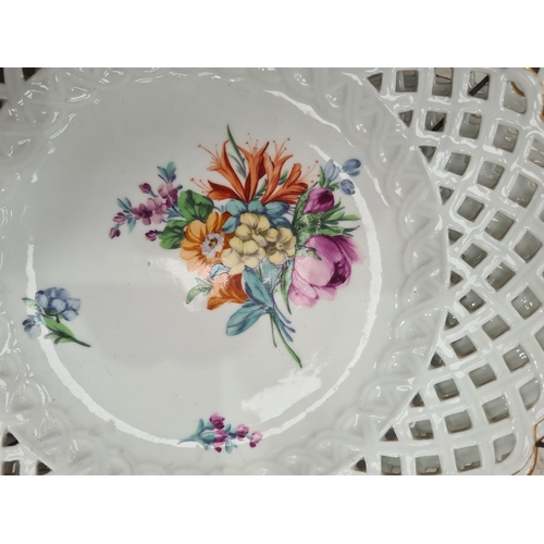 329 - Six hand painted Dresden Plates with pierced rims, with central floral decorations, 9