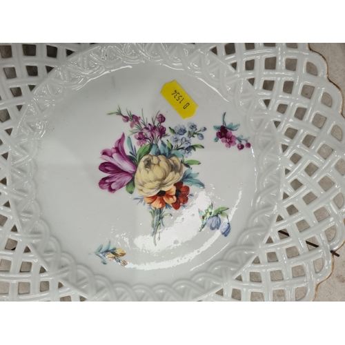 329 - Six hand painted Dresden Plates with pierced rims, with central floral decorations, 9