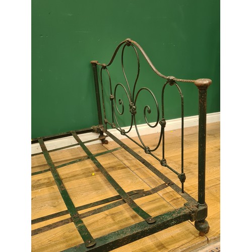 394 - A green painted French Low Bed with floral and scrolled designs, including rails and slats. (R11).