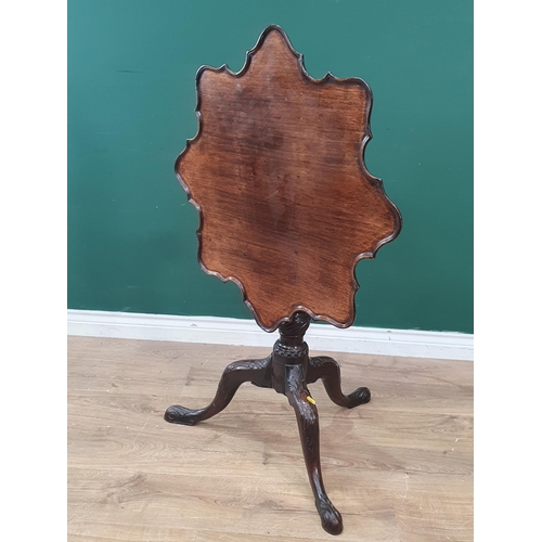 286 - A Georgian mahogany tilt-top Table with shaped dished top on fluted and spiral turned column and car... 