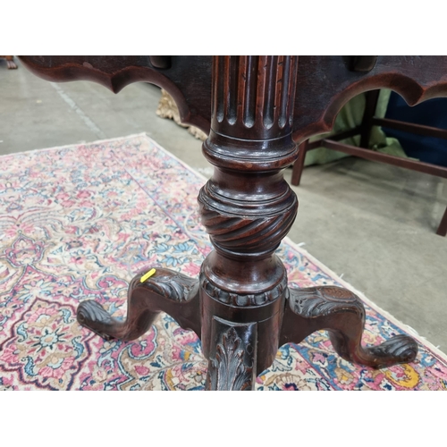 286 - A Georgian mahogany tilt-top Table with shaped dished top on fluted and spiral turned column and car... 