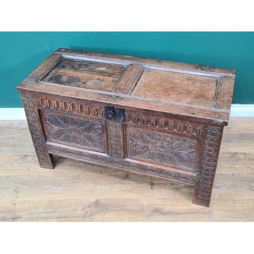 340 - A 17th Century joined oak Coffer with sunken two panel lid above nulled frieze and carved two panel ... 