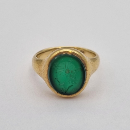 164 - An Intaglio Seal Ring the green stone carved head in profile in 18ct gold, ring size N, approx 6.20g... 