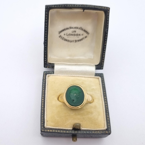 164 - An Intaglio Seal Ring the green stone carved head in profile in 18ct gold, ring size N, approx 6.20g... 