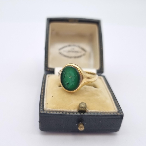 164 - An Intaglio Seal Ring the green stone carved head in profile in 18ct gold, ring size N, approx 6.20g... 