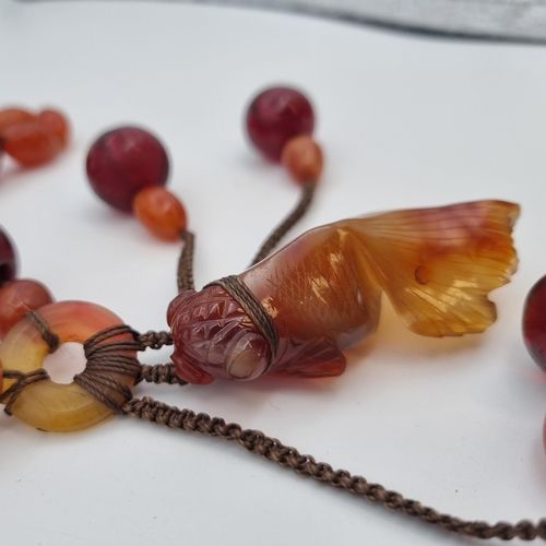 165 - An Agate and red bead Necklace with carved agate fish pendant