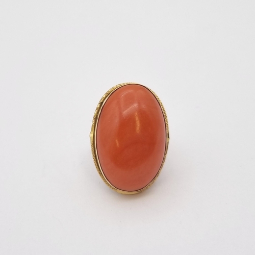 173 - A large Coral Ring set oval cabochon, stamped 750, ring size L 1/2, approx 10.90gms