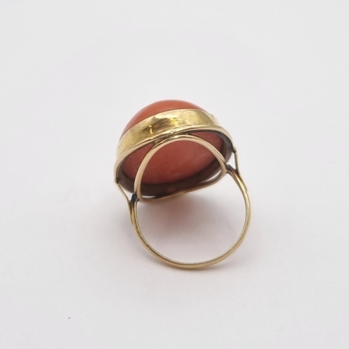 173 - A large Coral Ring set oval cabochon, stamped 750, ring size L 1/2, approx 10.90gms