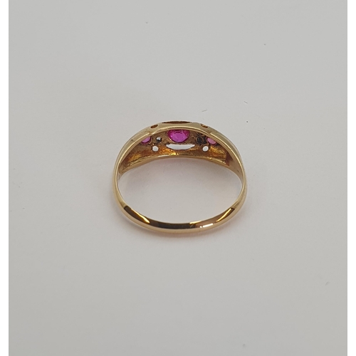 180 - A Ruby and Diamond Ring pavé-set three graduated round rubies with pairs of rose-cut diamonds betwee... 