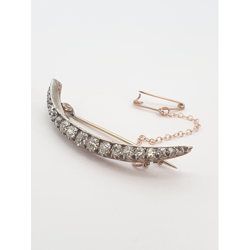 181 - A Victorian Diamond Crescent Brooch set graduated old-cut stones in silver backed with gold, unmarke... 