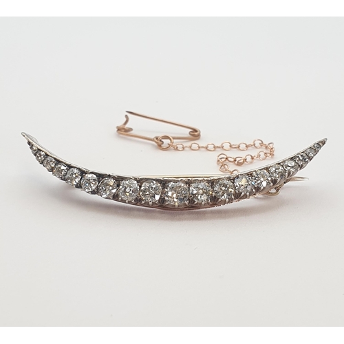 181 - A Victorian Diamond Crescent Brooch set graduated old-cut stones in silver backed with gold, unmarke... 