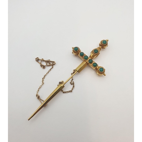 184 - A gold Jabot Pin formed a sword set turquoise, approx 7.50cms long, approx 4.70gms