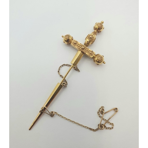 184 - A gold Jabot Pin formed a sword set turquoise, approx 7.50cms long, approx 4.70gms