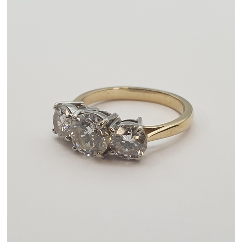 191 - A Diamond three stone Ring claw-set graduated brilliant-cut stones, estimated total diamond weight 1... 