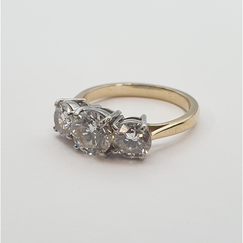 191 - A Diamond three stone Ring claw-set graduated brilliant-cut stones, estimated total diamond weight 1... 