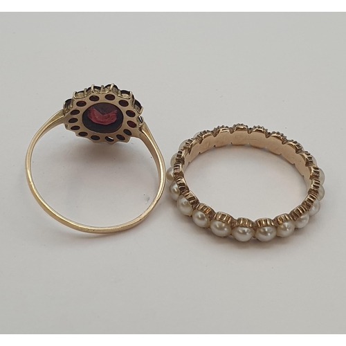 202 - A Garnet Cluster Ring set oval-cut stone within smaller round stones in 9ct gold, ring size O 1/2, a... 