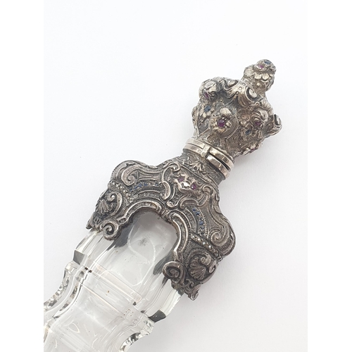 206 - A 19th Century cut glass Scent Bottle with intricate silver mounts set rubies, sapphires and seed pe... 