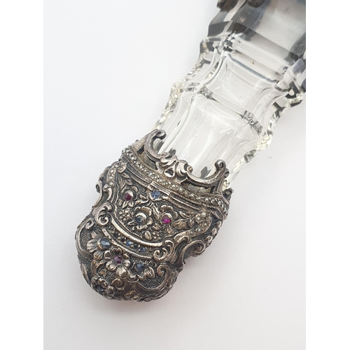 206 - A 19th Century cut glass Scent Bottle with intricate silver mounts set rubies, sapphires and seed pe... 