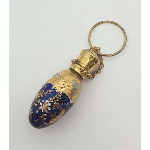 213 - A Bohemian blue glass Scent Bottle with gilt and enamel decoration, approx 5cms