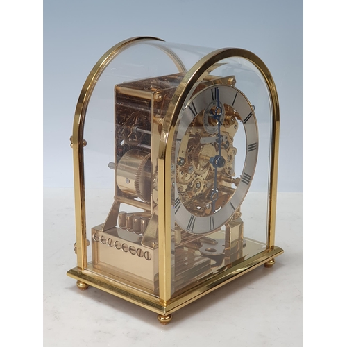 227 - A Kieninger three-train brass Mantel Clock with rounded arched glazed case having silvered chapter r... 