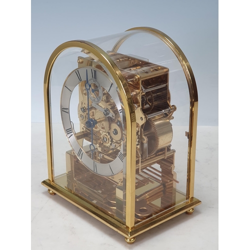 227 - A Kieninger three-train brass Mantel Clock with rounded arched glazed case having silvered chapter r... 