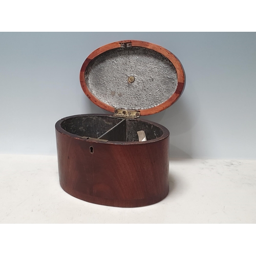 237 - A Georgian mahogany oval Tea Caddy with crossbanded and fan inlaid top, enclosing two divisions, 8in... 