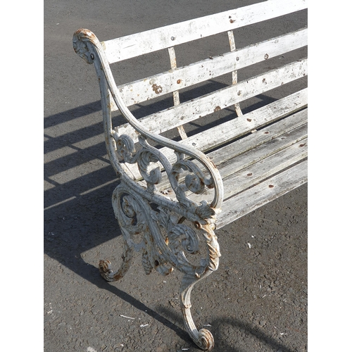 251 - A Decorative cast iron and wooden slatted three seater Garden Bench, the cast supports with scrolled... 