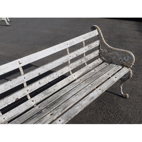 251 - A Decorative cast iron and wooden slatted three seater Garden Bench, the cast supports with scrolled... 