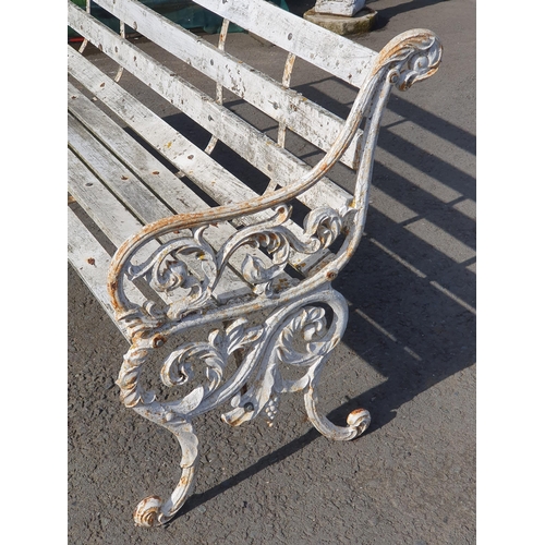 251 - A Decorative cast iron and wooden slatted three seater Garden Bench, the cast supports with scrolled... 