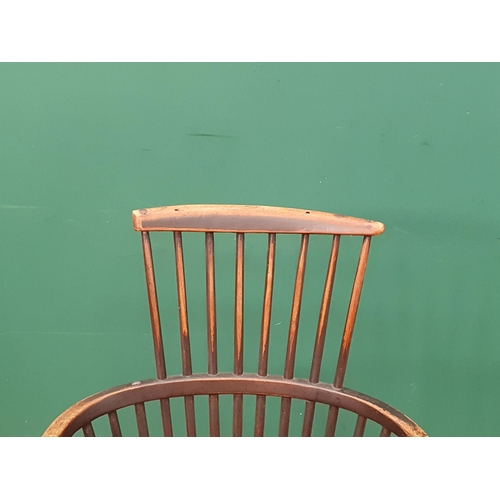 267 - A 19th Century stick back ash and elm Chair with comb top rail raised on turned supports united by H... 