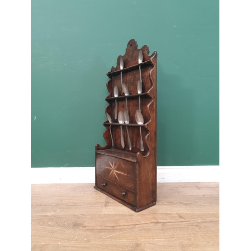 276 - An antique oak Welsh Spoon Rack with shaped raised back above a star inlaid compartment with sliding... 