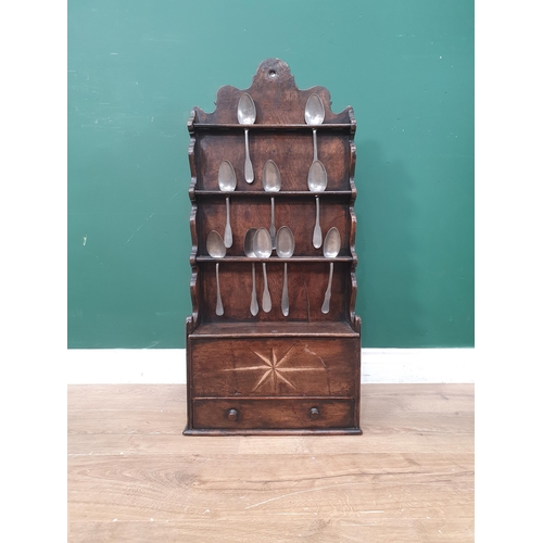 276 - An antique oak Welsh Spoon Rack with shaped raised back above a star inlaid compartment with sliding... 