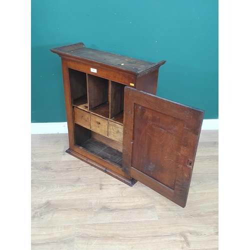 277 - An antique oak Spice Cupboard having single carved panelled door compartments and drawers, 2ft 7in H... 