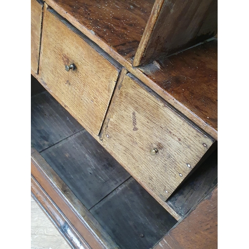 277 - An antique oak Spice Cupboard having single carved panelled door compartments and drawers, 2ft 7in H... 