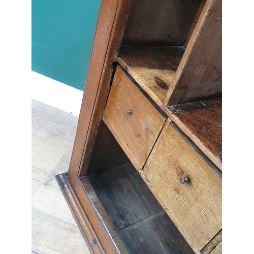 277 - An antique oak Spice Cupboard having single carved panelled door compartments and drawers, 2ft 7in H... 