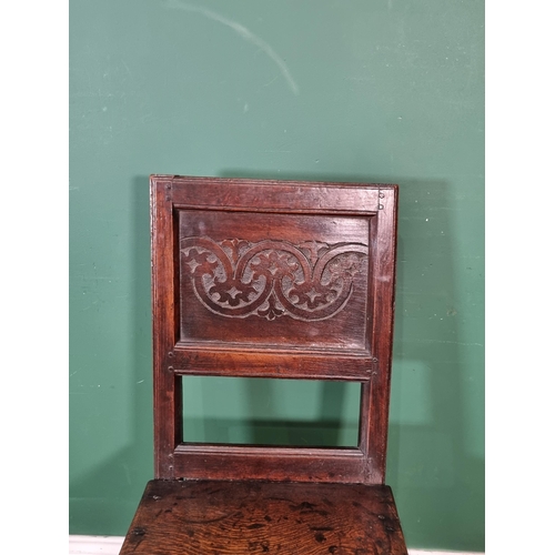 279 - A 17th Century oak Single Chair with leafage carved panel back raised on turned and square supports ... 