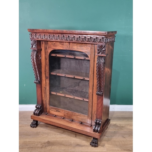 289 - A 19th Century rosewood Display Cabinet with carved frieze above a single glazed door enclosing thre... 