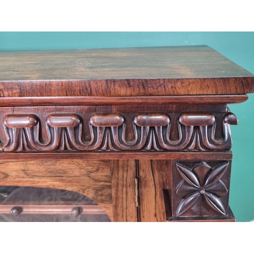 289 - A 19th Century rosewood Display Cabinet with carved frieze above a single glazed door enclosing thre... 