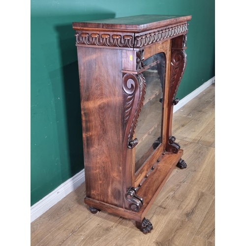 289 - A 19th Century rosewood Display Cabinet with carved frieze above a single glazed door enclosing thre... 