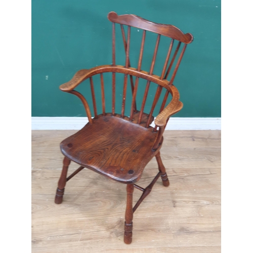 291 - An antique ash and elm country comb-back Elbow Chair with shaped top rail, shaped seat, raised on tu... 