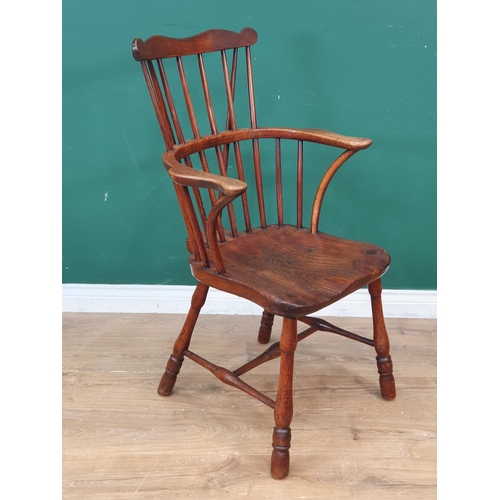 291 - An antique ash and elm country comb-back Elbow Chair with shaped top rail, shaped seat, raised on tu... 