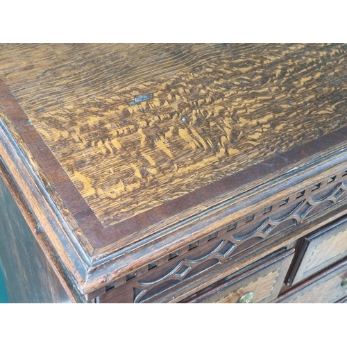 292 - A 19th Century oak and chequer banded Chest with a blind fret carved secret frieze drawer above thre... 