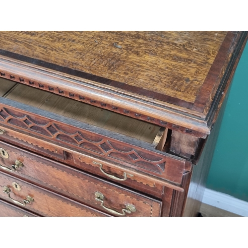 292 - A 19th Century oak and chequer banded Chest with a blind fret carved secret frieze drawer above thre... 