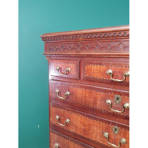 292 - A 19th Century oak and chequer banded Chest with a blind fret carved secret frieze drawer above thre... 